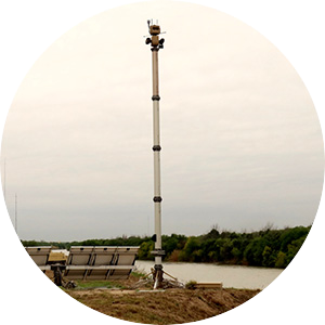 photo of a surveillance tower next to a body of water